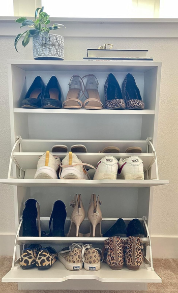 reviewer's white cabinet with shoes inside