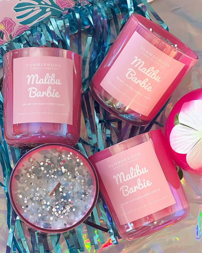 four pink malibu barbie candles with glitter on top 