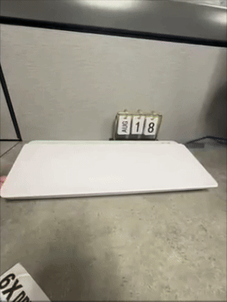 Someone lifts a wireless keyboard to uncover  a concealed  enactment      underneath. The calendar supra  shows August 18