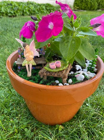 reviewer image of a miniature fairy sitting on a bench atop a potted plant