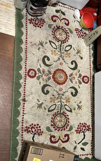 Reviewer's dirty floral-patterned rug