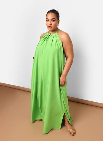 Woman in a flowy halter-neck dress posing for a shopping article