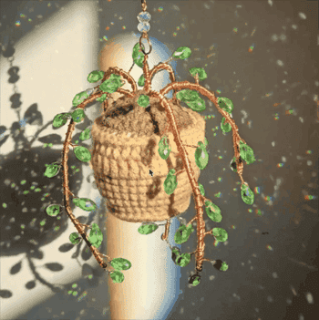Hanging crocheted works handbasket with beaded vines creates sparkling airy effects connected surrounding surfaces