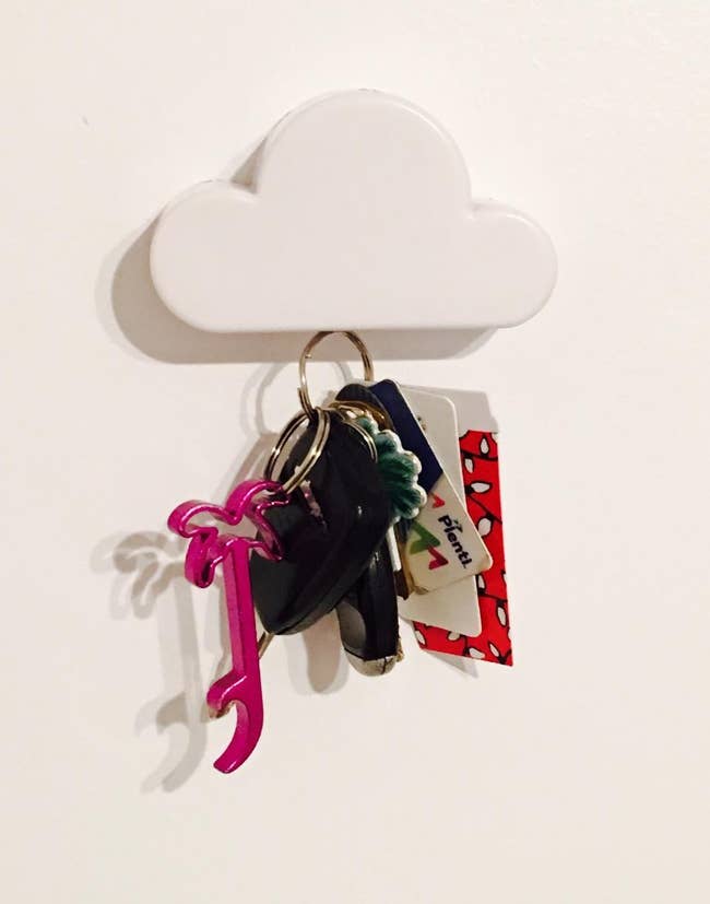reviewer pic of cloud-shaped magnetic key holder with set of car keys on wall