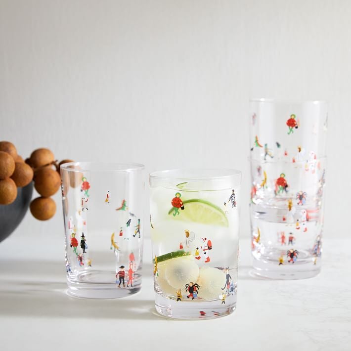 clear drinking glasses with illustrations of people in many different halloween costumes