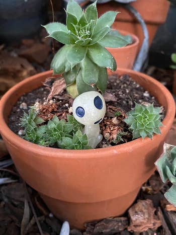 alien planter figurine in planter 