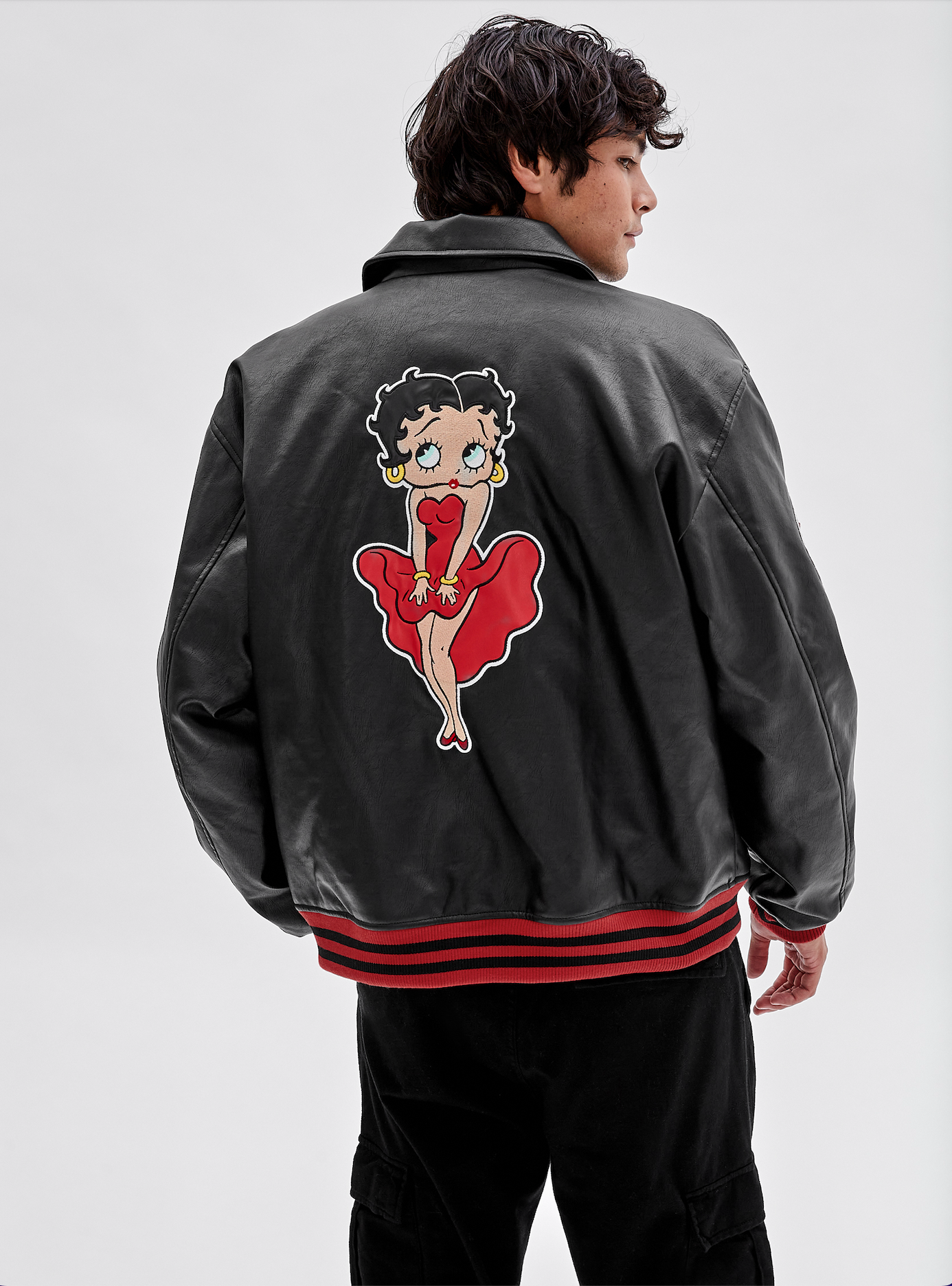A button-up faux leather jacket with a patch of Betty Boop on one sleeve