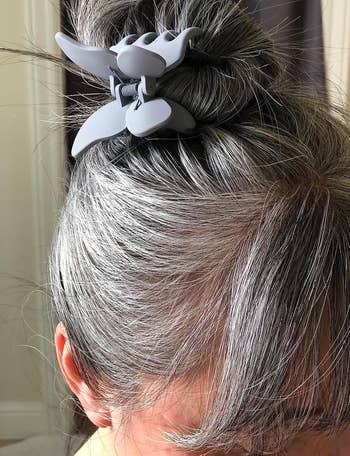 Close-up of a person's hair styled in a bun with a large hair clip