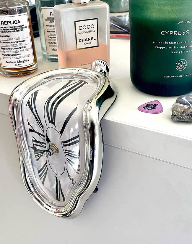 silver clock on a reviewer's shelf