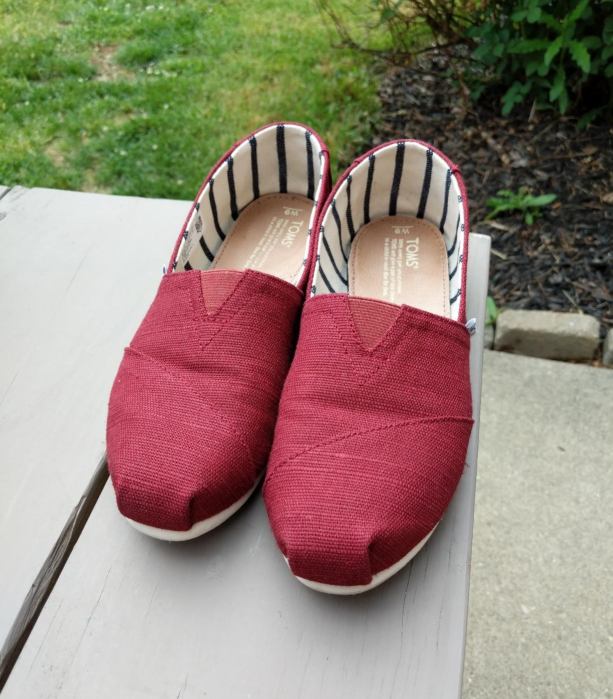 reviewer photo of their pair of red canvas slip-ons