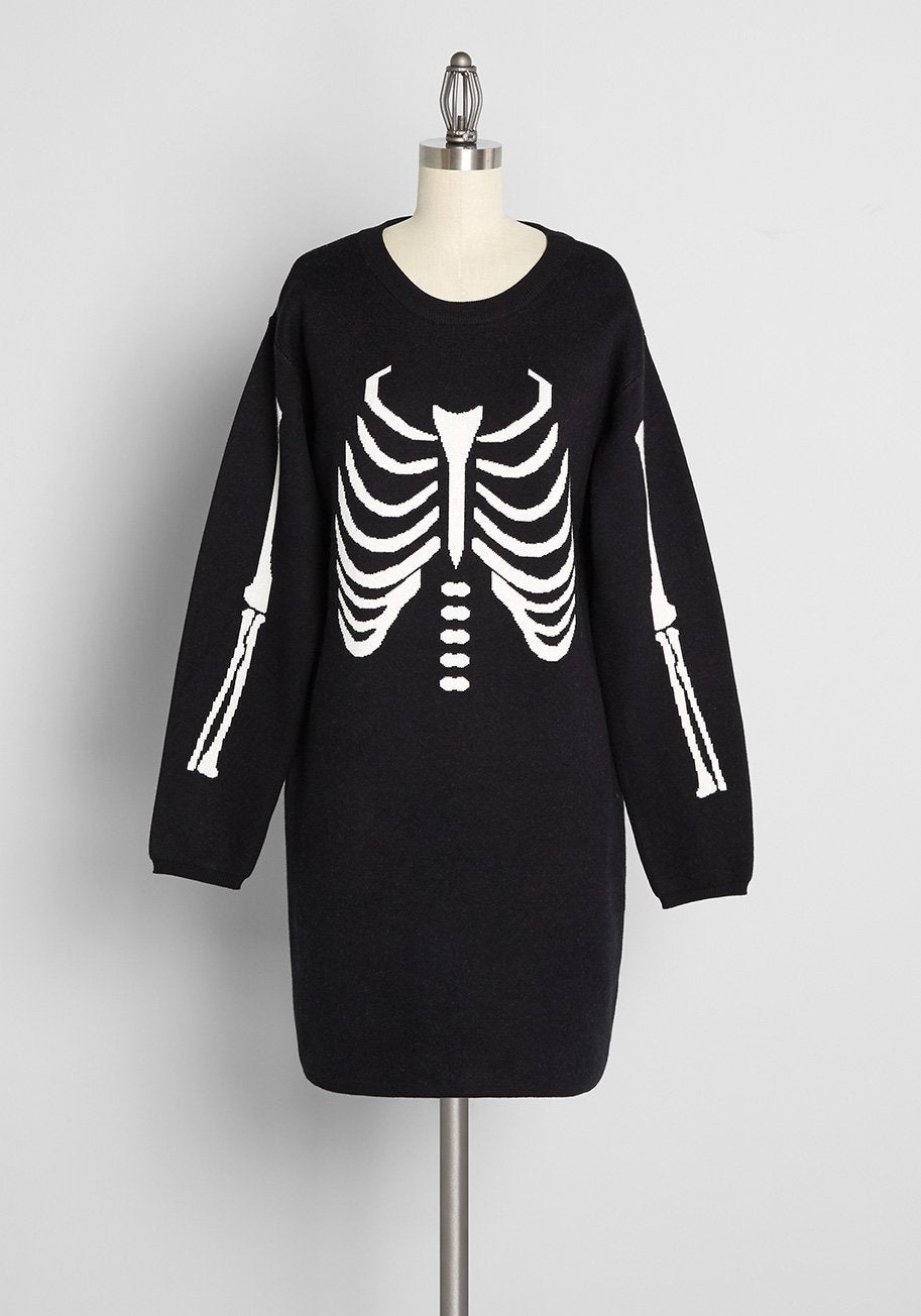 a black long sleeve sweater dress with a skeleton design on it