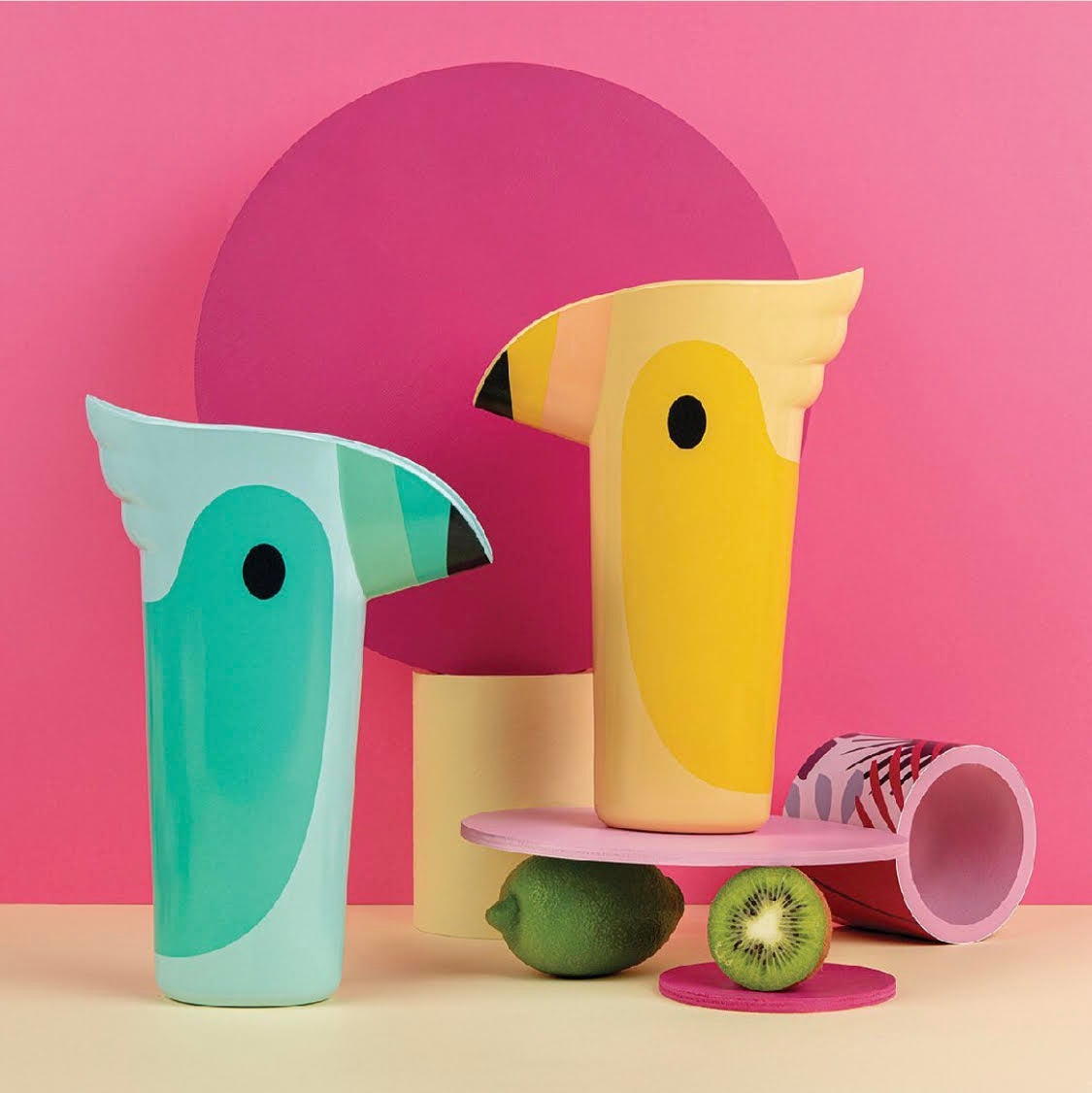 teal and yellow small pitchers shaped like parrots with the beak as the spout