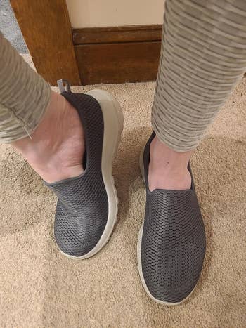 Person wearing casual slip-on sneakers and textured pants, lasting connected a carpeted floor
