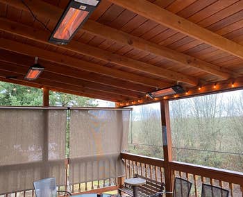 Three heaters hung up on the ceiling of a reviewer's covered deck