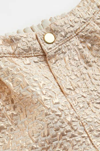 a close up of the detail of the shorts that have a gold foil design on them