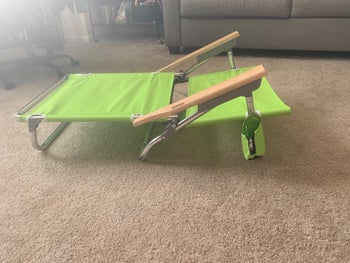 reviewer photo of the green beach chair in a flat position 