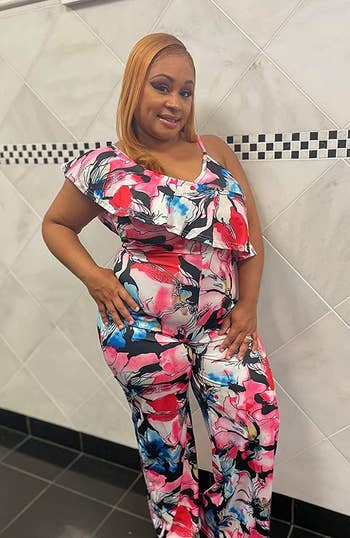 reviewer wearing the jumpsuit in a multicolored print