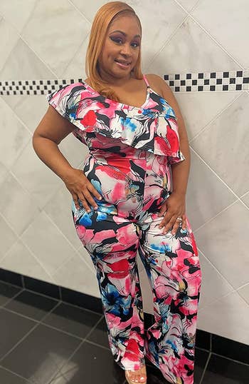 reviewer wearing the jumpsuit in a multicolored print