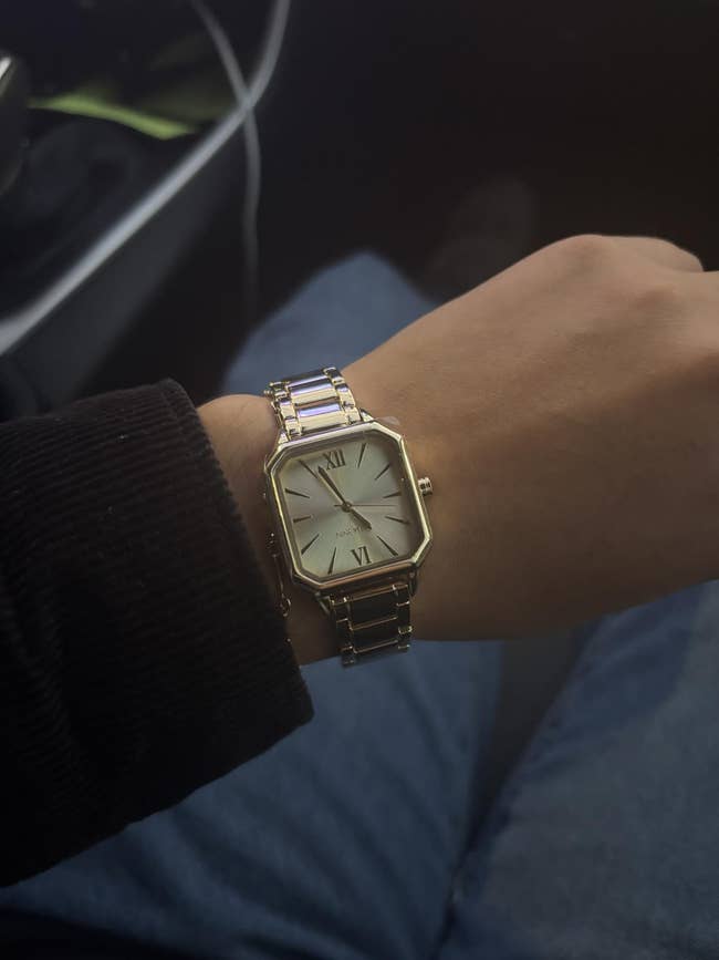 Wrist wearing a stylish rectangular ticker with a metallic set and Roman numerals, featured successful an nonfiction astir buying for luxury timepieces