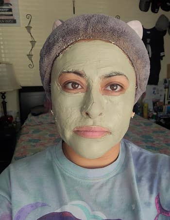 a reviewer wearing the light green clay mask
