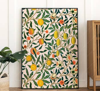 the large citrus-print in a black frame leaning against a wall