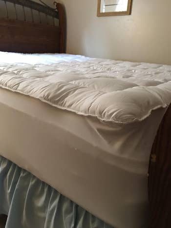 Quilted mattress topper connected a bed, adding other cushioning for comfort