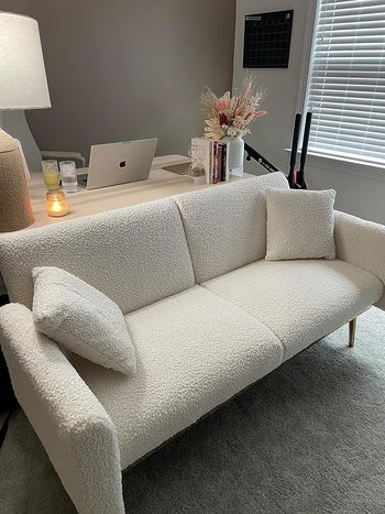 the white teddy fabric sleeper sofa in reviewer's office