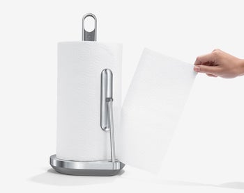 Model ripping a paper towel from a roll on the holder