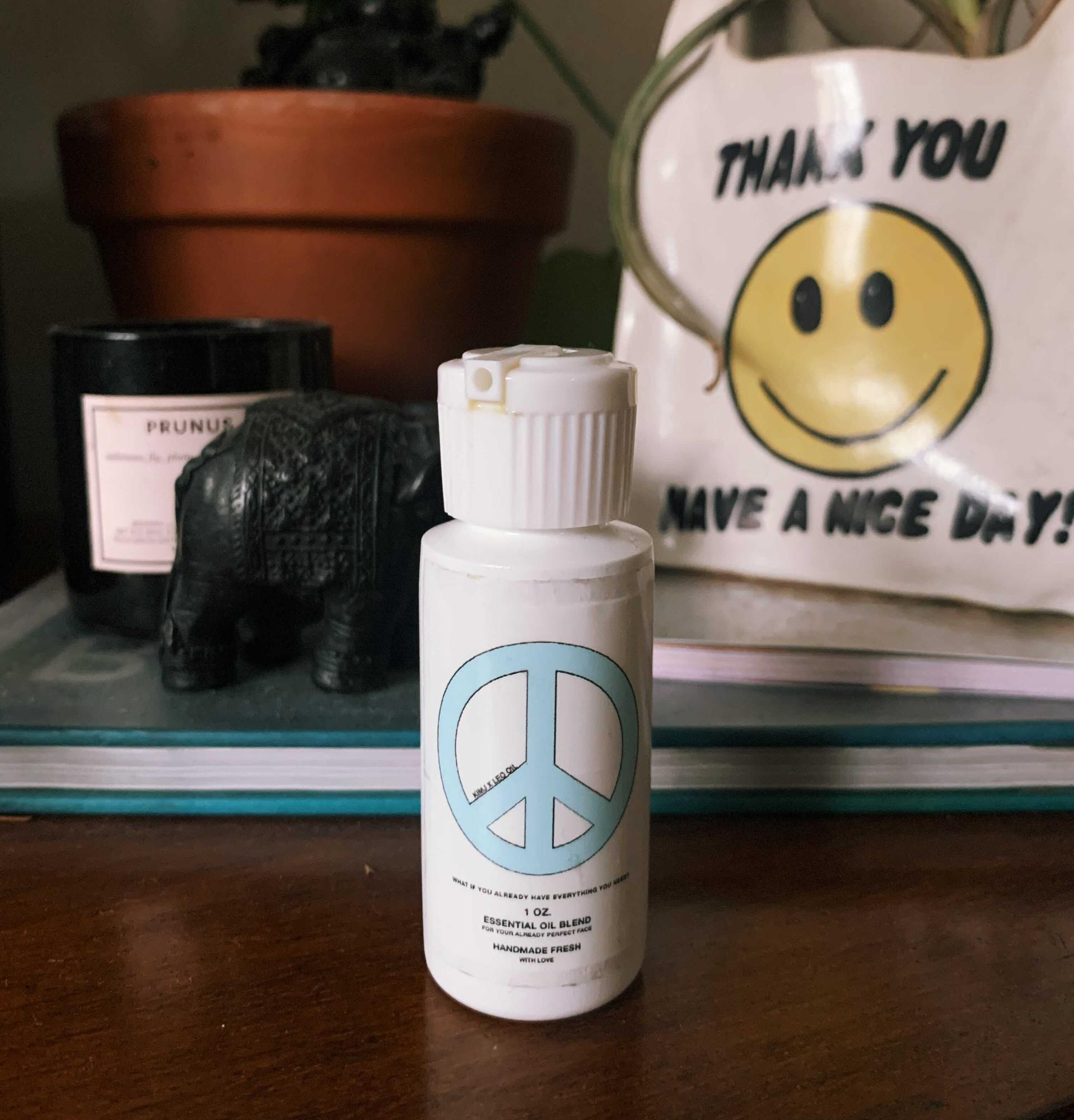 small bottle of the oil with a peace sign on it
