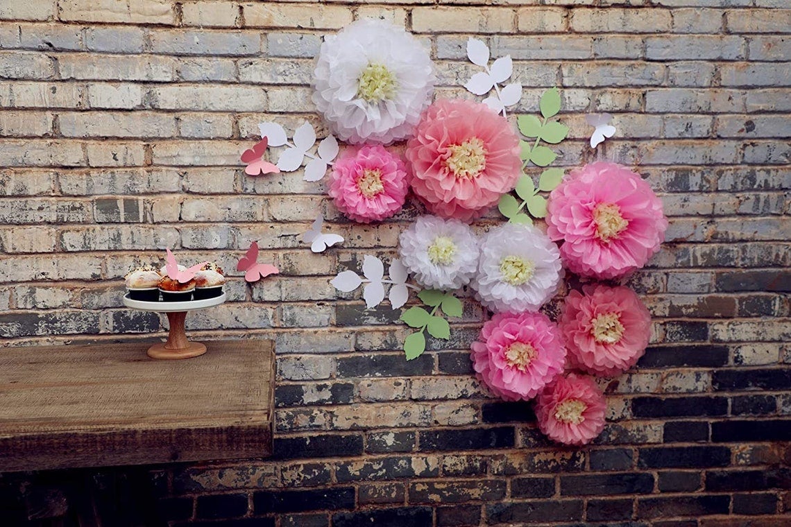 paper flowers, leaves, and butterflies on wall