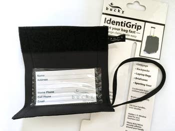 reviewer photo of the unrolled luggage tag to reveal personal info