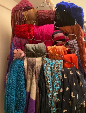 all the scarves neatly organized on a looped coat hanger