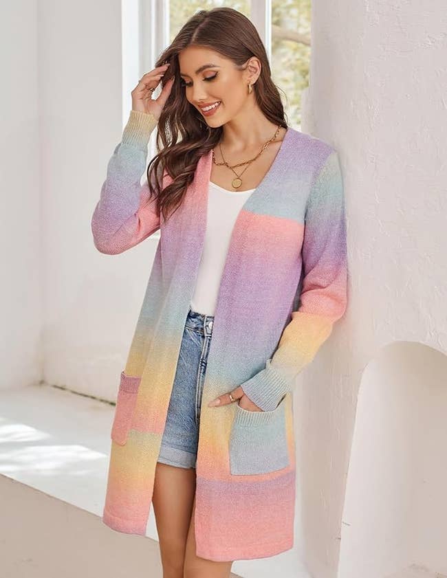 model wearing open front knit cardigan in gradient rainbow color