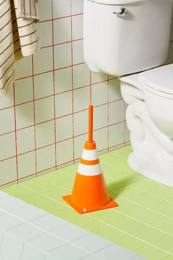 toilet brush in a traffic cone shaped holder