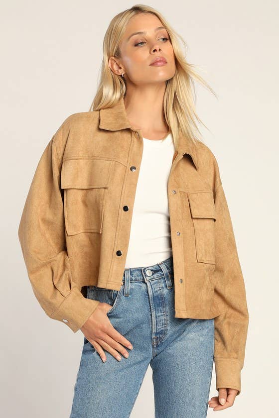 a model wearing a cropped tan suede shacket over a white tee and blue jeans