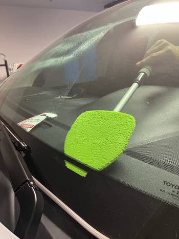 cloth triangle on long stick cleans windshield