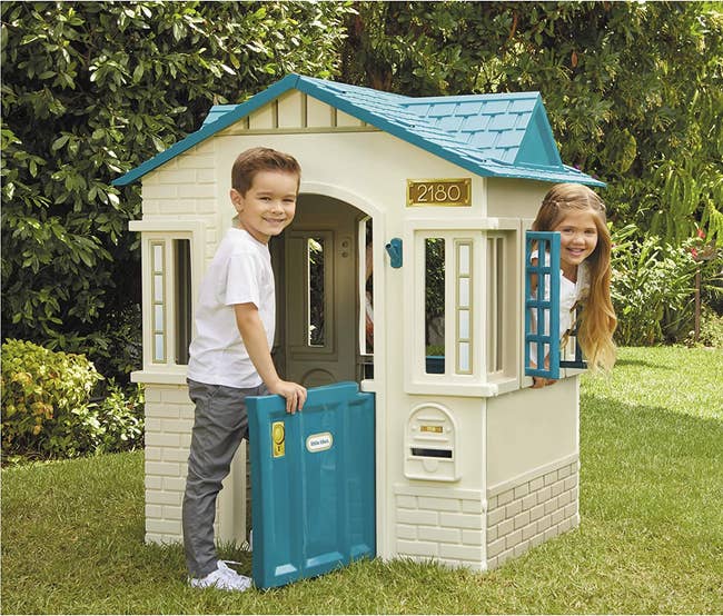 two children playing in a play house