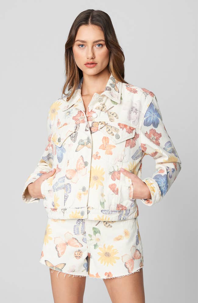 model in colorful printed jacket with hands in pockets