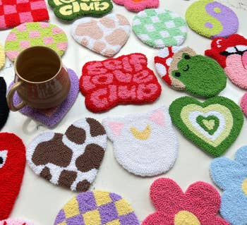 close up shot of some of the mug rugs, including the checkerboard design, the hearts, and the 
