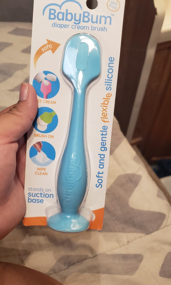 reviewer holding package with the blue spatula inside