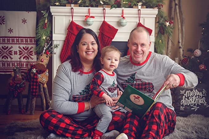 a woman, a man, and a child in plaid pajama pants with coordinated shirts