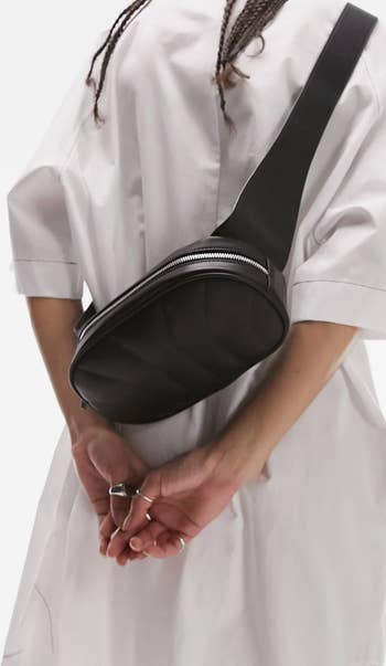 A model wearing the bag as a crossbody on their back