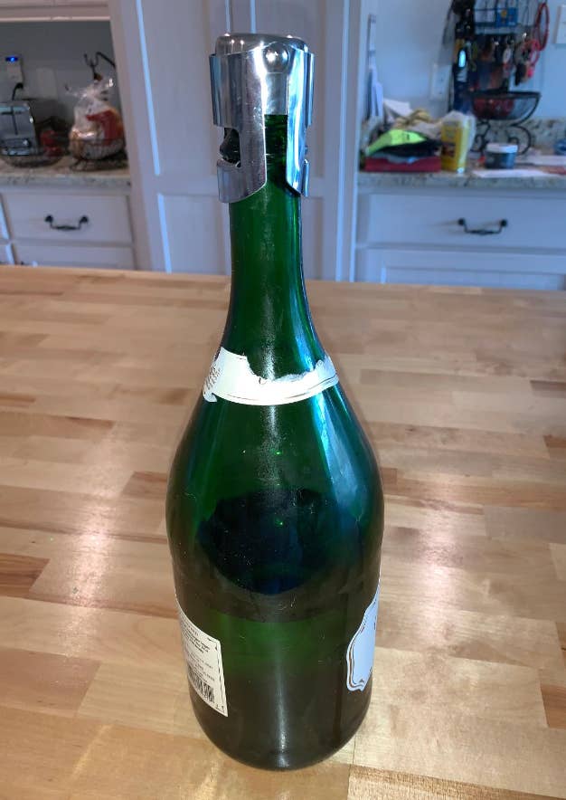 Bottle with a small metal topper on it 