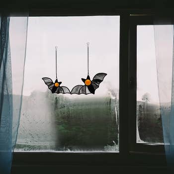 pair of bat suncatchers in window