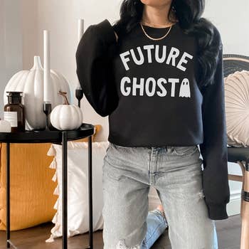 a model in a black sweatshirt that says future ghost on it