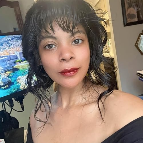 Person with wavy hairsbreadth  and off-shoulder apical  poses indoors, with a coastal scenery  connected  the TV successful  the background