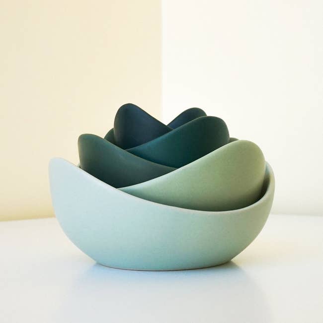 the green ceramic bowls stacked to look like a lotus flower