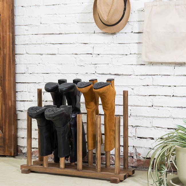 lifestyle photo of boots on inverted wooden boot rack