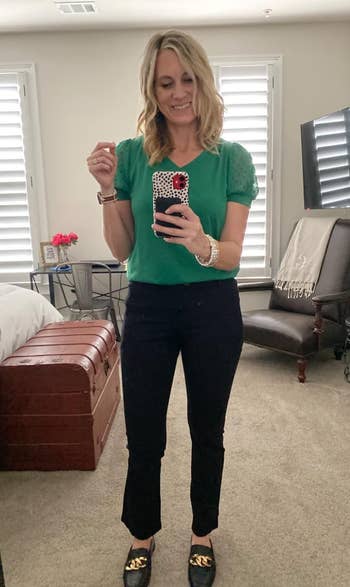 reviewer in green short sleeve tee with sheer swiss dot puff sleeves