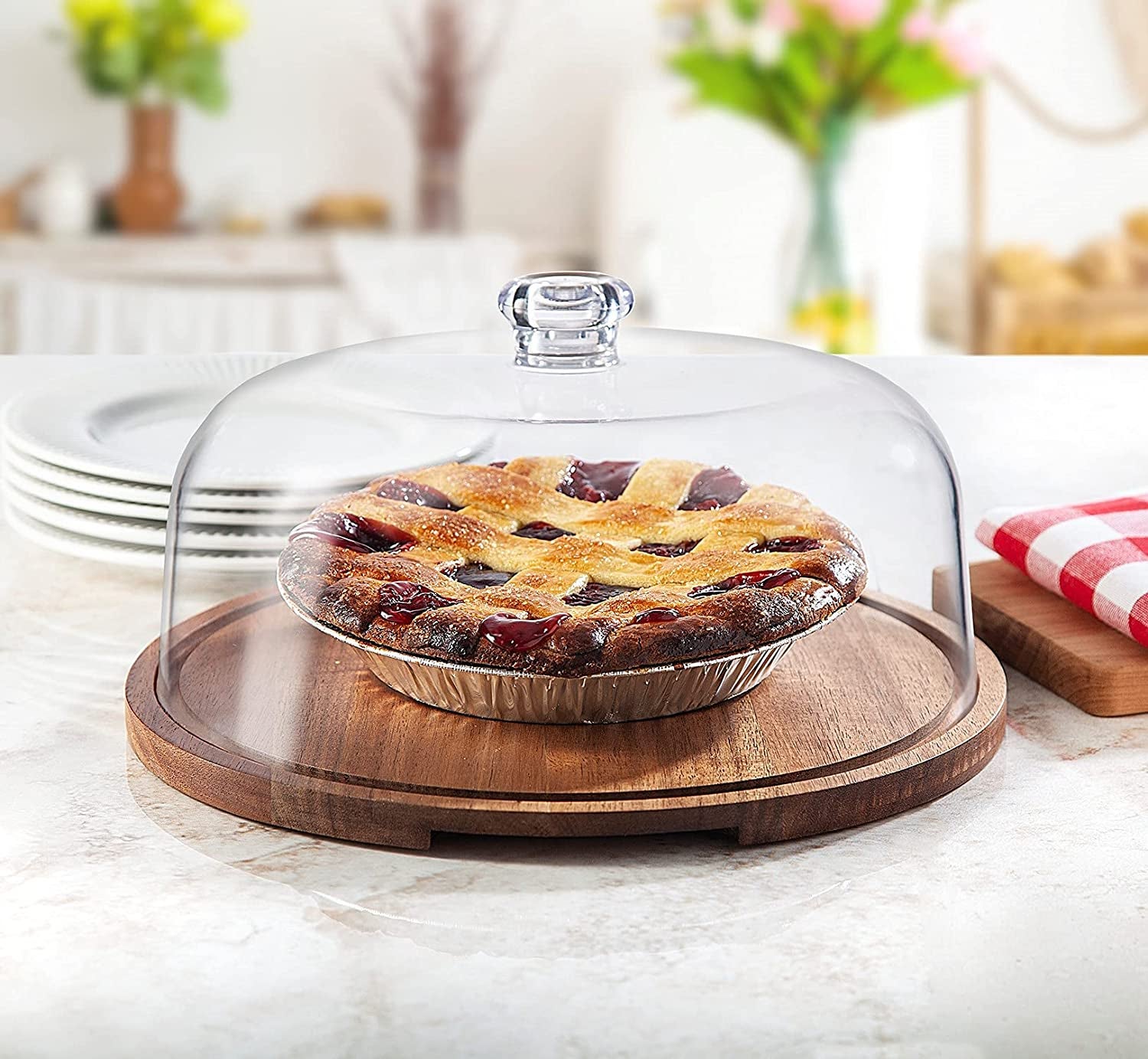 the glass and wood stand with a pie underneath